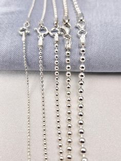 Welcome to our store! Discover the elegance of our 925 STERLING SILVER BALL BEADED CHAIN NECKLACE, a versatile and stylish piece perfect for both men and women. Whether you're looking for a choker chain for a pendant or a long chain to wear on its own, this silver ball necklace is the ideal choice. Handcrafted with care, this necklace is available in various sizes to suit your style and occasion. PRODUCT HIGHLIGHTS: PREMIUM QUALITY: Made from genuine 925 sterling silver, this ball beaded chain i Sterling Silver Jewelry With Round Beads Chain, Silver Ball Chain Necklace As A Gift, Classic Silver Jewelry With Beaded Chain, Sterling Silver White Gold Ball Chain Jewelry, Sterling Silver Jewelry With Ball Chain In White Gold, Sterling Silver Jewelry With White Gold Ball Chain, Silver Beaded Sterling Silver Chain Necklace, Silver Jewelry With Ball Chain And Round Beads, Silver Jewelry With Ball Chain For Gift