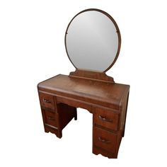 a wooden desk with a mirror on top and drawers underneath it, in front of a white background