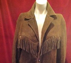 Here is a 1950s Vintage Fringed Jacket/ western jacket , this vintage jacket is fully lined with 2 front pockets.  Fringed at front pockets back and down sleeves. A great Vintage Piece for ALL you Great Vintage Lovers.  MEASUREMENTS : approximately  Length : 29 Inches ( Measured flat ) Chest : 22 - 2 Inches  ( Measured flat 1 side ) Shoulder to shoulder : 18 Inches  Sleeve : 24 Inches  Condition :  Vintage Condition  Some fringing missing, ripped at back on fringe, tear on the back, collar stained worn, jacket have wear, holes in the lining and marked, button missing, This piece does have issuses but in the right hands can come back to its former glory again. Please check all pictures carefully.   We ship Worldwide PLEASE request a shipping quote for All purchases outside of the UK,   Than Fitted Western Leather Jacket For Winter, Western Style Fitted Leather Jacket For Winter, Classic Fall Outerwear For Rodeo, Fitted Winter Outerwear For Western-themed Events, Fitted Outerwear For Western-themed Winter Events, Vintage Fall Outerwear For Ranch, Vintage Fall Outerwear For Western-themed Events, Vintage Brown Leather Jacket For Rodeo, Western Style Fitted Blazer For Fall