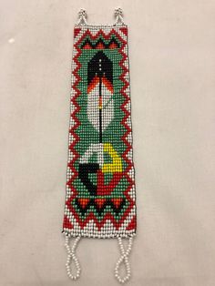 Bracelet in Guatemalan glass beadwor approximately 7” long x 2” wide. This design is a copy of a Native North American design, made by Native Guatemalans. This beadwork is done in the homes of Indigenous Artists living in the highlands of Guatemala in Central America. This design is a copy of a Native North American design, made by Native Guatemalans.  This beadwork is done in the homes of Indigenous Artists living in the highlands of Guatemala in Central America. eBay integration by White Southwestern Beaded Bracelet, White Beaded Southwestern Bracelet, Traditional Handmade Rectangular Beads, Bohemian White Rectangular Bracelets, Bohemian White Rectangular Bracelet, White Bohemian Rectangular Bracelet, Traditional Green Beaded Bracelets, Loom Designs, Native Artwork