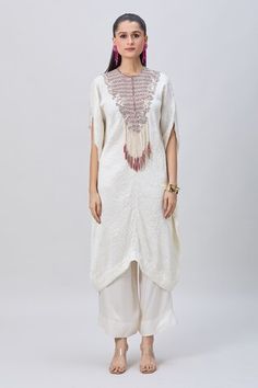 Ivory crushed kaftan with silver dori work embellished yoke and tassel details. Comes with solid pant. - Aza Fashions White Traditional Sets With Tassels, Traditional White Sets With Tassels, White Bohemian Kurta With Mirror Work, White Mirror Work Kaftan For Festive Occasions, Bohemian White Kurta With Mirror Work, White Kaftan With Mirror Work For Eid, Festive White Kaftan With Resham Embroidery, White Bohemian Embellished Sets, Festive White Embellished Kurta