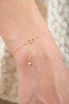 A 14k solid recycled yellow gold chain with a delicate seed pearl intricately encased between strands of gold. Crafted by hand in New York. The Bracelet features a secure clasp and is detailed with a small pearl at the end. Dainty Gold Chain Bracelet With Pearl Charm, Dainty Gold-plated Pearl Chain Bracelet, Dainty Gold Bracelets With Pearl Chain, Yellow Gold Plated Bracelets With Pearl Chain, Delicate Yellow Gold Plated Chain Bracelet, Adjustable Yellow Gold Bracelet With Pearl Chain, Gold Minimalist Pearl Bracelet With Adjustable Chain, Delicate Gold Chain Bracelet With Pearl Charm, Delicate Gold Plated Bracelet With Chain