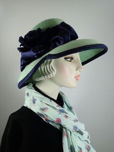 You'll look great in this pretty green and navy wool felt hat! It can easily transition from Winter to early Spring and is perfect for any dressy occasion. Imagine walking into church with this beauty! The flattering asymmetrical wide brim hat had a slight turned down brim with a cut out on the right side. It's topped with a gorgeous, extra wide navy wired ribbon band and double loop bow that's topped with a vintage navy velvet rose. So elegant! This hat that will be the envy of everyone who see London In March, Special Occasion Hats, Velvet Rose, Womens Hat, Hat Wool, Green Hat, Navy Velvet, Green Hats, Navy Lace