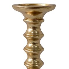 a gold colored candle holder on a white background