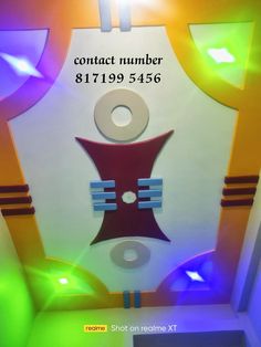 the ceiling is decorated with different colors and shapes, as well as an information sign that says contact number 81199456