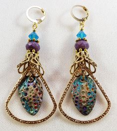 Hand-Painted Earrings. The centerpiece of these earrings are the beautiful hand-painted on copper with resin charms made by Washington State artist Kristi. I accented them with rounded triangle connectors, vintage brass bead caps, purple faceted Czech glass beads and turquoise Swarovski crystal bicone beads. These earrings are 3 inches long including the pure brass round lever back closures. One Of A Kind I can send it gift wrapped (free of charge), if requested. Vintage Multicolor Brass Earrings, Nickel-free Bronze Artsy Earrings, Artsy Brass Dangle Jewelry, Bohemian Enamel Drop Earrings, Copper Teardrop Earrings With Patina, Bohemian Hand-painted Copper Jewelry, Bohemian Hand Painted Copper Jewelry, Soldered Enamel Drop Earrings, Nickel-free Teardrop Artsy Earrings