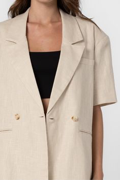 Half length sleeves Classic lapel collar One-button closure Single breast pocket Back vent Lined Fits oversized. Model measurements: Height 5'9", Bust 30.5", Waist 23.5", Hips 33.5" | Wearing a S/M. 85% Linen, 15% Cotton | Lining : 100% Polyester Summer Business Outerwear With Lapel Collar, Lapel Collar Summer Outerwear For Business, Single Button Summer Outerwear With Suit Collar, Single Button Outerwear With Suit Collar For Summer, Summer Blazer With Hidden Button Closure, Summer Button-up Blazer With Double Button Closure, Collared Office Blazer With Pockets, Oversized Linen Blazer For Workwear, Oversized Button-up Blazer For Work