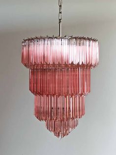 a pink chandelier hanging from a ceiling