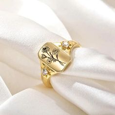 Elevate your style with our Combined Birth Flower Ring - a symbol of familial love and connection, beautifully encapsulated in a dainty and minimalist design. This exquisite signet ring celebrates the unique bond shared between family members, making it a perfect gift for yourself or a cherished loved one. 🔸 Personalized Engraving: Customize the ring with the birth flowers of your loved ones, with space for up to 6 flowers. Each flower represents a special individual in your family, creating a Birth Flower Ring For Promise, Elegant Birth Flower Ring For Wedding, Engraved Flower Ring For Wedding, Elegant Birth Flower Ring, Elegant Wedding Ring With Birth Flower Detail, Elegant Birth Flower Ring For Gift, Elegant Birth Flower Ring As Gift, Elegant Birth Flower Ring Gift, Elegant Engraved Flower Ring For Wedding