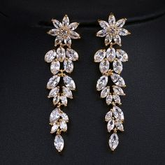 14K Gold plated Copper bridal and bridesmaids clear CZ diamond tassel fashion earrings. Wedding jewelry dangle ear stud earrings. Bridal flower diamond like crystal long dangle ear studs.Classic charm in a cascading dangle of clear crystal gemstones makes these earrings truly stunning. The elegant ear studs add an extra feminine touch to your simple yet elegant look. Versatile and chic, the pair will be a nice addition to a bridal outfit or suitable for any special occasion. The earrings are mad Hair Accessories Crown, Diamante Earrings, Jewelry Rose Gold, Bridal Earrings Drop, Wedding Earrings Drop, Prom Jewelry, Wedding Accessories Jewelry, Wedding Bridal Jewellery, Long Dangle Earrings