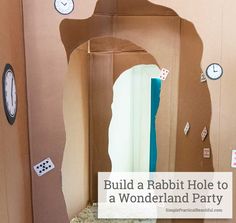 a cardboard rabbit hole to a wonderland party with dices and clocks on the wall