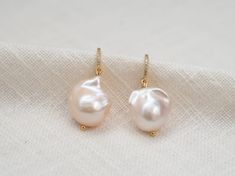 KYOTO Large Baroque Pearl Earrings - Pure Glam! Meet KYOTO - your new go-to for elegance and sparkle! These real freshwater pearl earrings feature stunning 12-14mm baroque pearls dangling from gold vermeil or sterling silver CZ settings. Perfect for bridal bling, wedding dazzle, or a fab gift for her. Why You'll Love Them: 🍋 Glam Design: Big, beautiful 12-14mm baroque pearls with dazzling CZ. 🍋 High Quality Materials: Choose gold vermeil or sterling silver. 🍋 Wedding Ready: Perfect for brides Wedding Diamond Earrings With Ear Wire, White Pear-shaped Hoop Earrings For Wedding, Pear-shaped Wedding Hoop Earrings, Wedding Pear-shaped Earring Pair, Real Pearl Earrings, Baroque Pearl Earrings, Freshwater Pearls Earrings, Freshwater Cultured Pearls, Pearl Drop