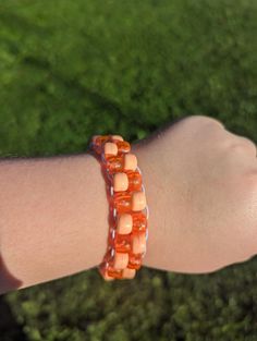 Handmade Orange Kandi Ladder Bracelet, made with stretchy string. Adjustable Orange Bracelet Wristband, Adjustable Orange Wristband Bracelet, Handmade Adjustable Plastic Friendship Bracelets, Handmade Casual Plastic Bracelets, Handmade Orange Stretch Bracelet, Orange Handmade Stretch Bracelet, Adjustable Orange Stretch Bracelet, Casual Handmade Stretch Bracelets, Ladder Bracelet