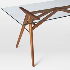 a glass table with wooden legs is shown