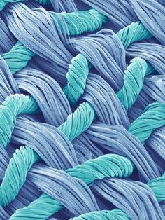 an image of blue and grey woven material with wavy lines on it's surface