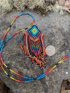 "Native style, hippie boho beaded pendant. This fringe pendant is made of round glass seed beads sewed together by hand. The cord is long and matches. Pattern purchased from lilibeadshop.patterns The cord is 28.5\" long and the pendant is 4.25\" long at longest fringe." Artisan Multicolor Beaded Necklaces With Fringe, Artisan Multicolor Beaded Necklace With Fringe, Festival Colorful Beads Pendant Necklace, Adjustable Artisan Beaded Fringe Necklace, Festival Pendant Beaded Necklace With Colorful Beads, Festival Colorful Beaded Pendant Necklace, Bohemian Beaded Pendant Necklace For Beach, Festival Round Beaded Fringe, Handmade Bohemian Heishi Beads Earrings