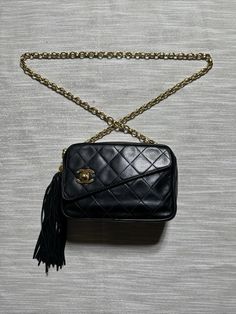 This vintage Chanel Bijoux camera handbag is a must-have for any fashion enthusiast. With a stunning argyle/diamond pattern and a sleek black exterior color, this small shoulder bag is perfect for adding a touch of elegance to any outfit. The bag features a zip and turn lock closure, with a handle and tassel accent. The interior is lined with black lambskin and leather, and comes with a bag charm accessory. This classic CHANEL product is perfect for women who appreciate the timeless style of vintage fashion. Don't miss out on the opportunity to add this unique piece to your collection. Bag is made of 24k gold plated hardware and was made in 1991-1994 PRELOVED and VINTAGE so not in perfect condition but still good considering what year it’s from Does not include a dustbag or box but will be Camera Handbag, Classic Chanel, Argyle Diamonds, Fashion Enthusiast, Black Exterior, Small Shoulder Bag, Vintage Chanel, Handbag Purse, Diamond Pattern