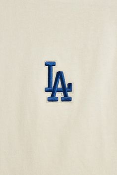 Los Angeles Dodgers tee by Pro Standard. Short sleeve tee cut from a cotton jersey in a standard fit with the classic team logo embroidered at the chest. Regular fit short sleeve t-shirt with a ribbed crew neck. Urban Outfitters exclusive. Features Pro Standard UO Exclusive Los Angeles Dodgers tee Los Angeles Dodgers tee from Pro Standard Regular fit Ribbed crew neck Short sleeves UO exclusive Content + Care 100% Cotton Machine wash Imported Size + Fit Model in Ivory is 6’1" and wearing size Lar Crew Neck T-shirt With Letter Embroidery For College, Game Day Crew Neck T-shirt With Letter Embroidery, Game Day Cotton Tops With Embroidered Logo, College Crew T-shirt With Embroidered Text, Game Day T-shirt With Embroidered Logo, Crew T-shirt With Letter Embroidery For College, College Crew T-shirt With Letter Embroidery, College T-shirt With Letter Embroidery, White Team Spirit T-shirt With Embroidered Graphics