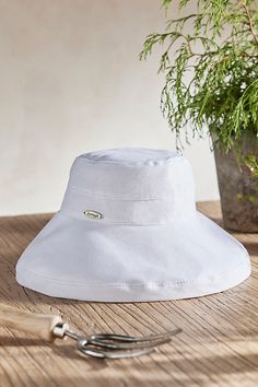 Handmade from lightweight and breathable cotton and branded with terrain exclusive details, this colorful crusher hat is perfect for a day at the beach or in the garden. Packable construction pairs with UPF 50 sun protection and an inner drawstring to assure a comfortable fit. | Cotton Crusher Hat in White at Terrain White Sun Hat, A Day At The Beach, Easter Shopping, Day At The Beach, Upf 50, In The Garden, Sun Hats, At The Beach, Sun Protection