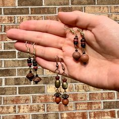 This set of three earrings are made of wooden beads harvested from vintage jewelry. Their design is abstract and geometric, but their material elicits natural beauty and wildlife. Your order includes all three pairs pictured. They are perfect for wearing in pairs, or mixing and matching! Wooden Beads Earrings, Bohemian Wooden Bead Earrings, Brown Wooden Bead Earrings, Unique Brown Wooden Beads Earrings, Artisan Brown Earrings With Wooden Beads, Unique Brown Earrings With Wooden Beads, Bohemian Brown Wooden Earrings, Wooden Beads Jewelry, Wood Bead Earrings