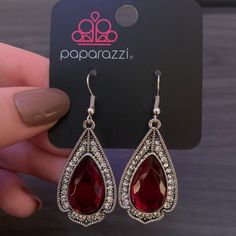 Paparazzi Superstar Stardom Red Dangle Silver Earring Party Ruby Earrings In Silver, Party Ruby Silver Earrings, Trendy Red Sterling Silver Jewelry, Trendy Red Jewelry For Festive Occasions, Trendy Red Festive Jewelry, Red Metal Earrings For Party, Red Elegant Nickel-free Teardrop Earrings, Trendy Red Metal Earrings, Trendy Red Teardrop Earrings