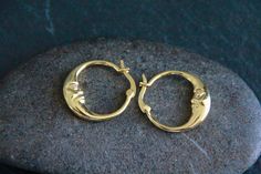 GOLD MOON CRESCENT HOOP EARRINGS - 22x20mm Bohemian pair of Gold hoop earrings, featuring a Moon Crescent. Lovely, boho design. Great for everyday wear, easy to put on and off. High quality Gold, bright, shiny. Micro Pave Clear Cubic Zirconia detail. Please note the size of this model: these are small-medium hoops, with a 22mm diameter. Each hoop of this pair only weights 2g. This listing is also available in PLATINUM: https://chandramalajewellery.etsy.com/listing/1651876686 SEE MORE HOOPS HERE: https://www.etsy.com/au/shop/ChandraMalaJewellery?ref=seller-platform-mcnav&search_query=hoops Description 18k Gold Cubic Zirconia detail Size: about 22mm long and 20mm wide Thickness: 3mm thick Pin: 0.7mm TO GO BACK TO MY STORE CLICK HERE:  https://chandramalajewellery.etsy.com * Moon Hoop Earrings, Good Hoop Earrings, Gold Moon Earrings, Earrings Gold Hoops, Boho Hoop Earrings, Moon Crescent, Indie Jewelry, Hippy Gifts, Ear Stack