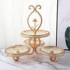 three tiered cake stand with glass plates on it