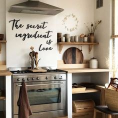 a stove top oven sitting inside of a kitchen next to wooden shelves filled with pots and pans