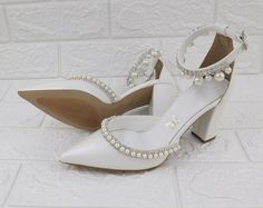 "Our block heel wedding shoes features a stunning pearls embellishment, The delicate cross front straps will flatter your feet and the addition of a padded insole will provide you with all day comfort for your special occasion. All Pelino shoes are made to ensure the highest level of comfort throughout the day, and have a soft foam inner lining. Heel Height: 8 cm/3.15\" (pictured) or 5 cm/1.96\" Full sizes only ** If you are unsure of your size, please contact me so I can assist you. ★ More Wedd White Shoes Wedding, Pearls Embellishment, Bridal Block Heels, Block Heel Wedding Shoes, Block Heels Wedding, Bridal Wedges, Pearl Heels, Wedding Wedges, Satin Wedding Shoes