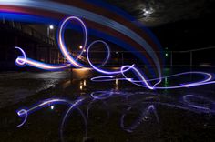 a blurry image of the word love is seen in front of a building at night