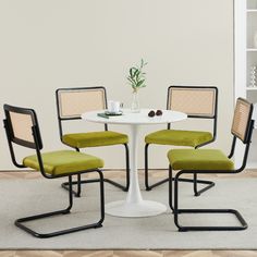 a white table with four chairs around it