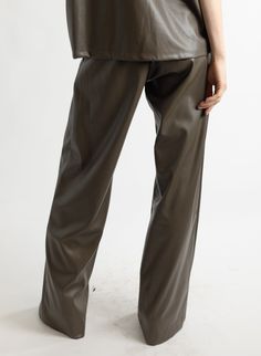 This style features: Mid-rise waist Wide leg Pleated trouser Front pockets Fly front with zipper and two buttons Fabric content: 100% PU outer Dry clean or hand wash only Designed by Meg in Brooklyn, NY. Made in the USA. High-waisted Leather Pants With Pockets For Work, Leather Trousers For Office, Leather Workwear Bottoms With Pockets, High-waisted Leather Pants For Business Casual With Belt Loops, Business Casual High-waisted Leather Pants With Belt Loops, Business Casual High-waisted Leather Pants, High-waisted Leather Pants With Pockets, Leather Bottoms With Pockets For Office, Leather High-waisted Pants With Pockets