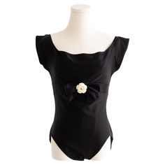 This iconic Chanel swimsuit, as seen on Helena Christensen, is a rare piece from the Spring/Summer 1990 collection. Featuring a scoop neckline, cap sleeves, and a black satin bow, it’s adorned with a sculptural off-white "Camellia" flower and a gold CC emblem at the front. In good condition with minor signs of wear such as light scratches on camellia and a little interior fading from sunscreen. Labeled in size FR42, I estimate it to comfortably fit a modern day sizes FR38-FR42 , please use the m Chanel One Piece Swimsuit, Chanel Swimwear, Chanel Swim, Vintage Chanel Swimsuit, Chanel Bow Top, Chanel Swimsuit, White Camellia, Chanel Suit, Chanel Vintage