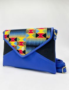 The Lulu clutch bag is the perfect companion for any modern wardrobe. Crafted with vegan leather and the finest African wax fabrics, this stylish clutch is sure to make a statement. With an adjustable strap and magnetic clasp closure, you'll enjoy maximum convenience with every wear. Make your mark with the Lulu clutch bag. Length - 12.75” Width - 0.75" Height - 8" Blue Shoulder Flap Bag With Magnetic Closure, Envelope Shoulder Bag With Detachable Strap For Daily Use, Daily Use Crossbody Clutch With Magnetic Closure, Travel Clutch Shoulder Bag With Magnetic Closure, Travel Crossbody Clutch With Magnetic Closure, Daily Use Envelope Shoulder Bag With Detachable Strap, Versatile Pouch Clutch With Adjustable Strap, Everyday Satchel Clutch With Magnetic Closure, Daily Use Flap Clutch Bag With Magnetic Closure