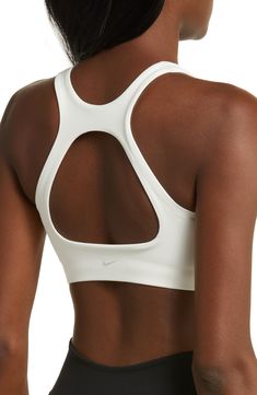 Get into your groove in this ultracomfy sports bra with signature Dri-FIT tech and a breezy back cutout to keep you cool and dry. Racerback Dri-FIT moisture-wicking technology Lined 80% polyester, 20% elastane Machine wash, line dry Imported Nylon Activewear With Built-in Bra For Sports, White Nylon Activewear With Built-in Padding, Nike Activewear With Built-in Bra For Workout, Athleisure Activewear With Built-in Bra For Sports, Nike Nylon Activewear With Go-dry Technology, White High Stretch Go-dry Sports Bra, Nike Sports Bra With Built-in Padding, Nike Sports Bra With Built-in Bra, Nylon Sports Bra