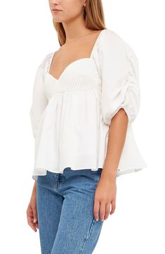 Puffed elbow-length sleeves frame this flouncy cotton blouse designed with a pintucked bodice and a smocked back. Sweetheart neck Elbow-length sleeves Partially lined 100% cotton Hand wash, dry flat Imported Blouse Designed, Cotton Blouse Design, English Factory, Concert Looks, Sports Blazer, Sweaters And Leggings, Cotton Blouse, Puff Sleeve Top, Comfortable Sandals