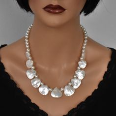 ♥ Ready to ship ♥ 100% handmade ♥ Packed in a gift box ♥ Custom length ♥ Teardrop Mother of Pearl beads, faux pearls, silver Add a touch of elegance to your outfit with this striking handmade White Mother of Pearl Bib Necklace.  The iridescent hues of the Mother of Pearl beads create a stunning statement piece that is perfect for any occasion.  This unique necklace is sure to turn heads and make you the center of attention wherever you go.  Handcrafted with care and attention to detail, this nec Pearl Bib Necklace, Personal Integrity, Chunky Statement Necklace, Sports Jewelry, Mother Of Pearl Necklace, Protection Stones, Necklace Unique, Unique Necklace, Necklace Beaded