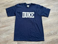 Dope 90s duke shirt Clean condition! Adult XL Please see pictures for exact detail. MEASUREMENTS Armpit to Armpit - 23 inches Length - 31.5 inches Duke Shirt, Logo University, T Shirt Logo, Duke Blue Devils, University Logo, College T Shirts, Blue Devil, Tshirt Logo, Gender Neutral