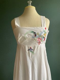 "This Dress !! A great light weight white cotton dress with the perfect amount of embroidered detail on the bodice, empire style with nice wide straps a side zipper for easy on and off and a stretchy back to make sizing easy  - tired eyelet detail bottom  - vintage size 11 please look at measurements  -Made by Young Edwardian circa 1960's -70's -Washed and ready to wear  Measurements laying flat: Underarm to underarm 17\" Length 59\" at empire 13\" (with additional stretch)  There is lots of stretch to this Dress fits size Small to Medium" Spring Cotton Embroidered Dress For Garden Party, Summer Embroidered Cotton Dress For Garden Party, Summer Cotton Embroidered Dress For Garden Party, Cotton Embroidered Dress For Garden Party, Bohemian Cotton Embroidered Dress For Garden Party, White Sleeveless Cotton Embroidered Dress, Summer Cotton Dress With Floral Embroidery, Vacation Cotton Dress With Floral Embroidery, White Sleeveless Embroidered Cotton Dress