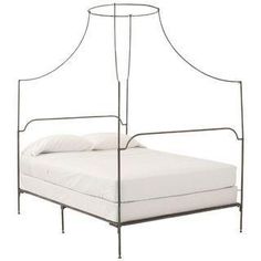 an iron bed frame with white sheets and pillows on it, against a white background