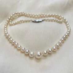 A beautiful graduated pearl necklace, on a vintage silver and pearl clasp. * 3mm - 7mm cultured Akoya pearls * hand knotted * 18ct white gold safety clasp * 17" necklace length (not your size? Message me.) Lovely quality classic cultured Akoya pearls with a beautiful bright lustre and pink undertones. These pearls are perfectly round and have hardly any flaws in their nacre. I have hand knotted between each of these gorgeous pearls and attached them to an 18ct white gold, hook in safety clasp. T Classic Single Strand Pearl Necklace With Round Beads, Vintage Akoya Pearl Drop Necklace, Vintage Akoya Pearl Necklace For Anniversary, Classic Pearl Drop Necklace, Classic Cream Pearl Necklace With Pearl Charm, Classic Pearl Drop Necklace For Anniversary, Classic Cream Necklace With Pearl Chain, Classic Cream Pearl Chain Necklace, Classic Akoya Pearl Necklace For Anniversary