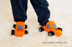 a person standing on top of a white rug wearing orange crocheted slippers