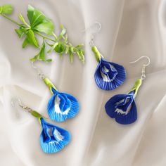 Handcrafted Clay Butterfly Pea Flower Earrings in Light and Dark Blue Embrace the enchantment of nature with our "Enchanted Blooms" earrings, featuring the delicate beauty of the butterfly pea flower, now immortalized in clay. Handcrafted with precision and care, these earrings come in two captivating shades: a serene light blue reflecting the sky at dawn, and a rich dark blue reminiscent of the deep ocean. Perfect for adding a touch of botanical elegance to any outfit, these earrings are not ju Blue Handmade Flower Drop Earrings, Handmade Flower Blue Jewelry As Gift, Blue Handmade Flower Jewelry For Gifts, Handmade Blue Flower Jewelry For Gifts, Blue Handmade Flower Jewelry As Gift, Elegant Blue Birth Flower Earrings, Blue Handmade Flower-shaped Earrings, Blue Drop Earrings With Handmade Flowers, Blue Flower Earrings With Birth Flower Detail