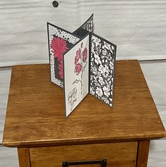 an open card is sitting on top of a wooden table