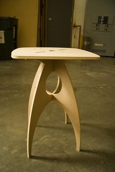 a wooden table sitting on top of a cement floor