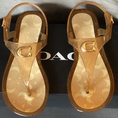 Coach Natalee Jelly Slingback Thong Sandals Color Dark Gold Size 5 Evoking A Youthful Charm, These Slingback Thongs Are Crafted Of A Semi-Transparent Rubber With A Jelly-Style Finish. Rubber Upper Thong Toe Adjustable Slingback Strap Polyvinyl Chloride Lining Polyvinyl Chloride Sole Imported Gold T-strap Sandals With Removable Insole, Coach Open Toe Adjustable Sandals, Summer Beach Jelly Slingback Sandals, Coach Adjustable Open Toe Sandals, Coach Adjustable Sandals For Beach, Trendy Coach Sandals For Vacation, Adjustable Coach Sandals For The Beach, Coach Sandals For Beach And Summer, Coach Sandals For Beach In Summer