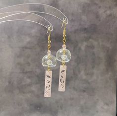 Elevate your style with these handmade earrings - an ideal blend of culture, craftsmanship, and elegance. They're perfect for any occasion!  🤍 Handmade with high-quality hollow glass charms, finished with 18K gold plated nickel free hypoallergenic earring hooks. They look stunning and eye-catching. We are now offering three colours of pendants for your choice! 🤍 Japanese wind chimes, also known as "Furin," which are believed to bring good luck and positive energy. Whether you're a fan of Japan Elegant Clear Earrings As Gift, Clear Drop Earrings For Anniversary, Traditional Rose Gold Earrings For Gift, Handmade Adjustable Earrings For Celebration, Unique Handmade Clear Earrings, Traditional Hypoallergenic Earrings As Gift, Traditional Hypoallergenic Earrings For Gift, Traditional Hypoallergenic Earrings For Gifting, Hypoallergenic Traditional Earrings As Gift