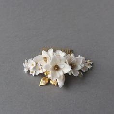 This timeless Magnolia flower comb, adding a touch of elegance to your hair. Details: HANDMADE IN FRANCE  ♥ Flower details are handcrafted they are lightweight, resistant. Japaneses beads, tarnish resistant jewelry wire, fresh water pearls. Gold plated leaf. Crafted with meticulous attention to details.  ♥ Magnolia earrings you will find here: https://www.etsy.com/fr/listing/675808244/boucles-doreilles-avec-des-fleurs?click_key=d4890027af3a865c2dbcc200d2ad3b85cc24f2a7%3A675808244&click_sum=83727 Magnolia Earrings, Hair Details, Wedding Headpieces, Flower Comb, Bridal Comb, Floral Headpiece, Magnolia Flower, Jewelry Wire, Luxury Bridal