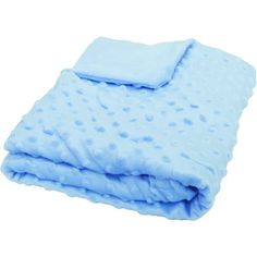 the blue blanket is folded up on top of the white background and it has polka dots