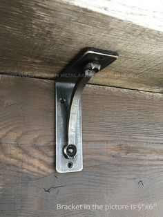 a metal hook on the side of a wooden door